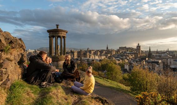 Photo shows students on Calton Hill overlooking city of Edinburgh