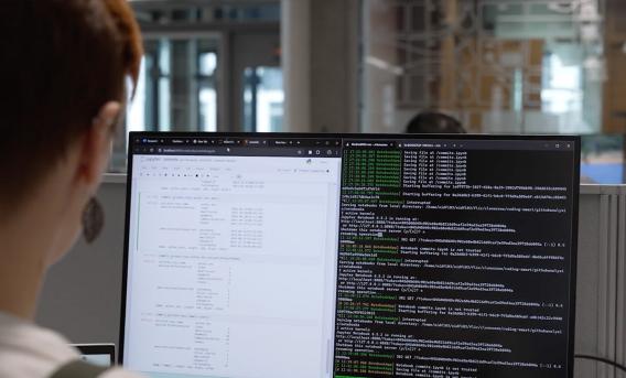 Photo shows student working on code.